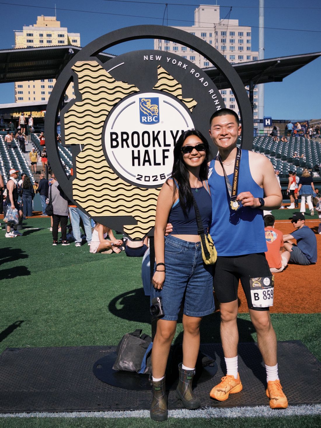 Alexander Yu holding his finisher medal at the RBC Brooklyn Half